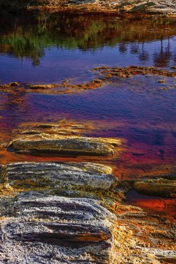 The rich, red-tinted waters of Rio Tinto reflect the surrounding landscape, highlighting the river's unique mineral-rich composition
