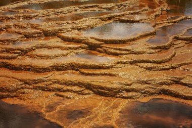 Sunset illuminates the terraced mineral pools, showcasing the vibrant geological layers at Rio Tinto