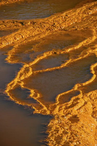 stock image Sunset illuminates the terraced mineral pools, showcasing the vibrant geological layers at Rio Tinto