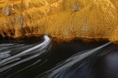 Vivid details of the iron-rich sediment and microbial mats along the banks of Rio Tinto.