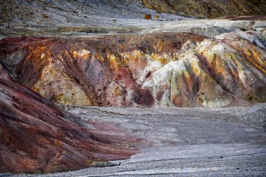 A striking landscape of multicolored geological formations at the Rio Tinto mines, marked by the passage of time and extraction