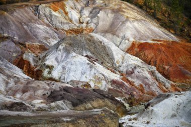 A striking landscape of multicolored geological formations at the Rio Tinto mines, marked by the passage of time and extraction clipart