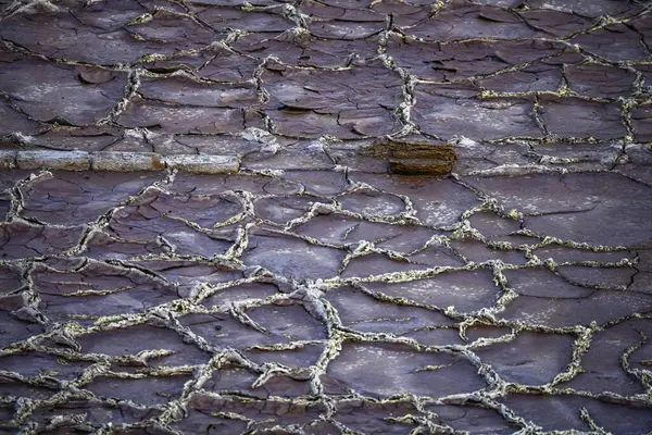 Overhead view of the dried-up mineral ponds at Rio Tinto, showcasing intricate patterns and textures left by evaporation