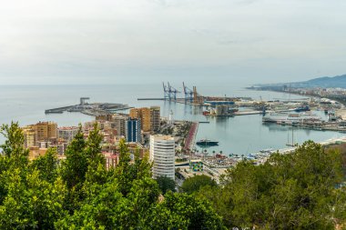 Wide-angle panorama of Puerto de Malaga, showcasing the bustling port, city architecture, and distant mountains
