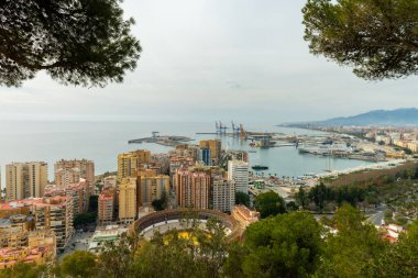 Wide-angle panorama of Puerto de Malaga, showcasing the bustling port, city architecture, and distant mountains