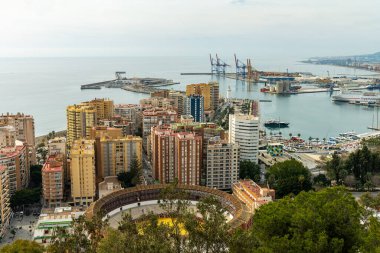 Wide-angle panorama of Puerto de Malaga, showcasing the bustling port, city architecture, and distant mountains