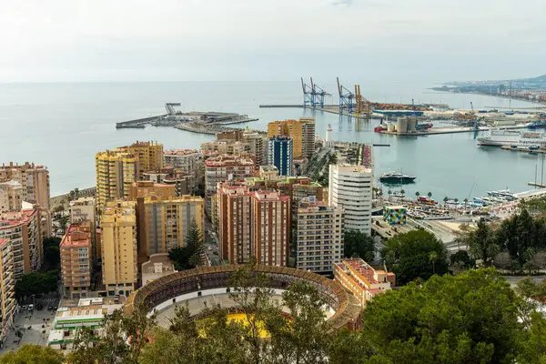 Wide-angle panorama of Puerto de Malaga, showcasing the bustling port, city architecture, and distant mountains