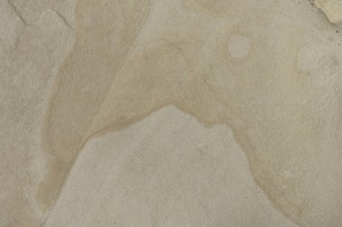 Close-up of a smooth sandstone surface featuring subtle natural patterns and textures. Perfect for backgrounds, nature themes, and geological studies.