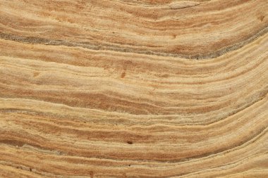 Close-up of intricate sandstone swirls and erosion patterns, highlighting the natural beauty and texture of sedimentary rock formations. Perfect for geological themes and backgrounds.