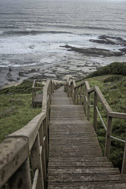 Günbatımında Portekiz 'de Carriagem Sahili' nin sakin bir manzarası var. Dalgalar kıyıya vuruyor..