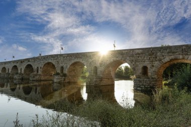 İspanya 'nın Merida kentindeki antik Roma köprüsü etkileyici taş kemerleriyle Guadiana Nehri boyunca uzanır..