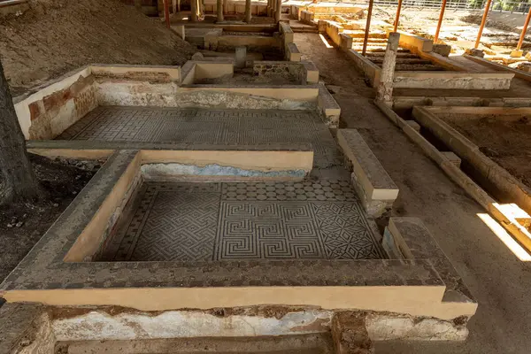 stock image A well-preserved Roman mosaic depicting intricate patterns and faded artwork, located in an ancient site in Merida, Spain. The mosaic showcases the artistic craftsmanship of Roman civilization.