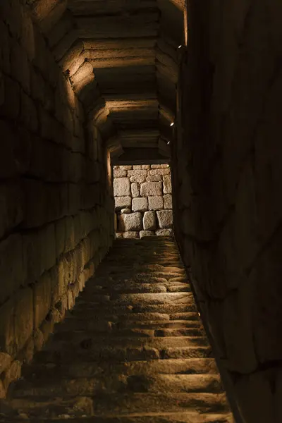 stock image A dimly lit stone passageway leading to an ancient structure in Merida, Spain. The rugged steps and walls showcase the architectural ingenuity of historical times