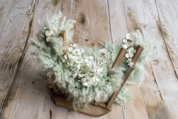 stock image A heart-shaped wooden bowl with white flowers and soft green fabric on a light background.