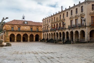 Traditional Spanish square with monuments and historic buildings clipart