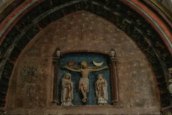 Çarmıha gerilen İsa, Meryem ve Yahya ile birlikte Gotik kemerde Calvary 'nin polikrom rahatlaması.