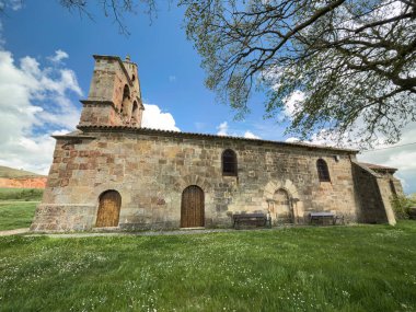 Çan gable, kemerli kapı ve kırsal taş duvarlı eski Roma kilisesi.