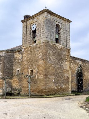İspanya, Castilla y Leon 'da çan kulesi ve saati olan taşra kilisesi.