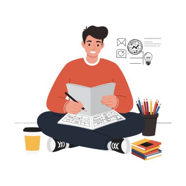 Neşeli genç bir adam elinde eskiz defteriyle yerde oturuyor, etrafı renkli sanat malzemeleri ve bir kahve fincanıyla çevrili..