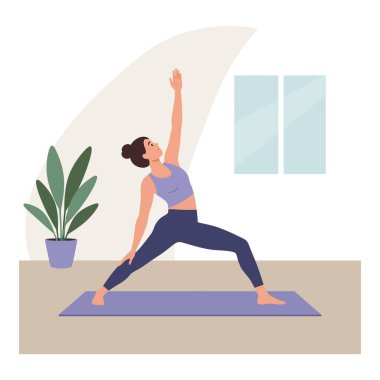Kadın, sakin, odaklanmış, huzurlu bir ortamda, bir saksı bitkisi ve pencerenin yanındaki paspasın üzerinde yoga yapıyor..