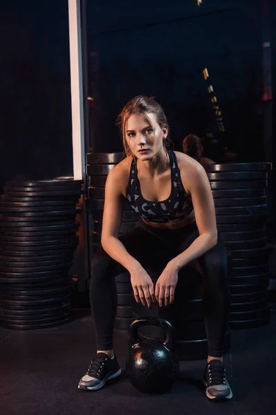 stock image Attractive young athlete with muscular body exercising crossfit. Woman in sportswear doing crossfit workout with kettle bell at the gym. Young healthy girl with a perfect figure.