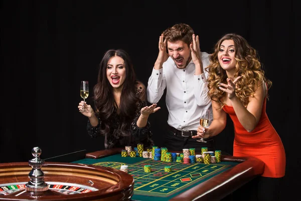 Two Young Women Man Roulette Table Black Background Emotions Players — Stock Photo, Image