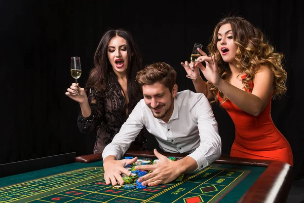 Two Young Women Man Roulette Table Black Background Emotions Players — Stock Photo, Image
