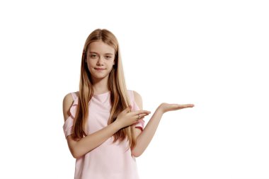 Studio portrait of a pretty blonde adolescent in a pink t-shirt isolated on white background in various poses. She expresses different emotions posing right in front of the camera, smiling and