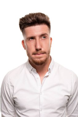 Studio photo of a good-looking man in a white shirt, looking away, isolated over a white background