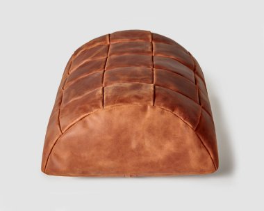 Ergonomic footstool cushion made of terracotta genuine leather for feet comfort while working at table. Handmade accessory for home and office interior design