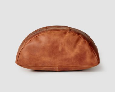 Comfortable and functional semi-cylindrical footrest cushion made of pieces of genuine terracotta leather. Artisanal accessory for interior design