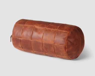 Ergonomic designed bolster cushion made of reddish-brown color genuine leather for decoration of living room sofa or study armchair. Hand-stitched natural products