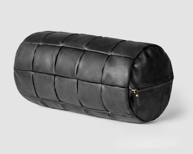Decorative bolster cushion made of patches of genuine tanned black leather with zipper for modern home decor. Handmade interior accessory