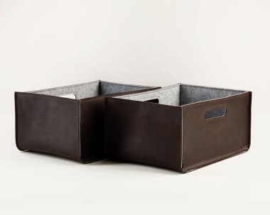 Two handcrafted boxes in brown faux leather with felt lining and handles for comfortable sorting and storage of things. Stylish accessories to organize home and office space