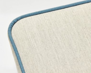 Bej keten döşeme kumaş dokusunu gösteren mavi borularla yakın plan.