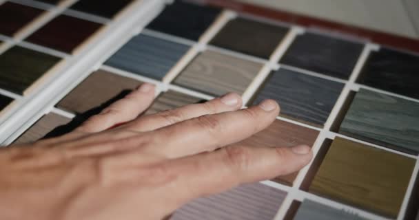 Man Chooses Paint Color His Hand Runs Wooden Samples Repair — Stock Video