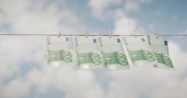 Mavi gökyüzüne karşı bir çamaşır ipinde 100 euro 'luk banknotlar kuruyor. Para aklama kavramı.