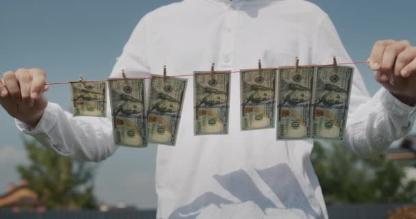 Man Holds Clothesline His Hands Which Banknotes Hang Money Laundering — ストック動画