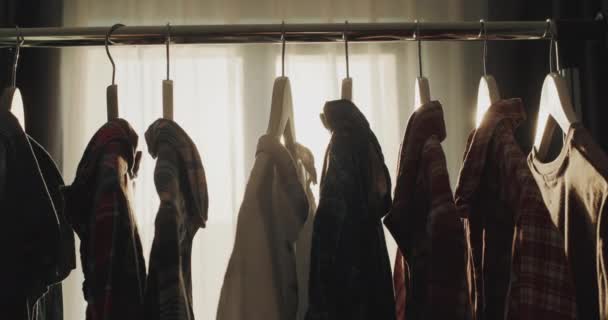 Rack Hangers Clothes Rays Setting Sun Shines Window — стоковое видео