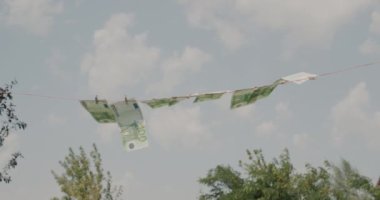 Euro banknotes hanging in the wind on a clothesline. Money laundering concept