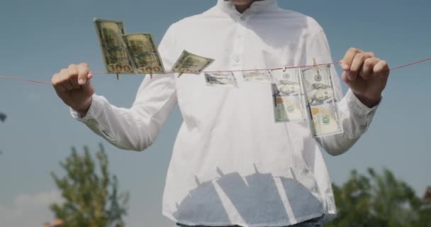 Man Holds Clothesline His Hands Which Banknotes Hang Money Laundering — Stock video