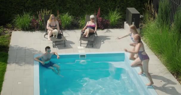 Family Relaxing Pool Mother Daughter Jumping Water — Stock Video