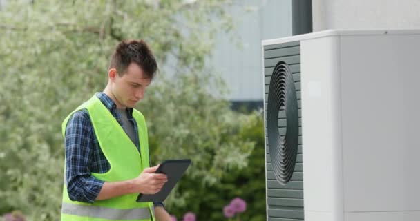 Young Engineer Sets Heat Pump Private House Uses Tablet — Stock Video