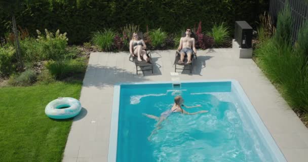 Family Child Relaxes Small Pool Villa Parents Sunbathe Child Swims — Stock Video