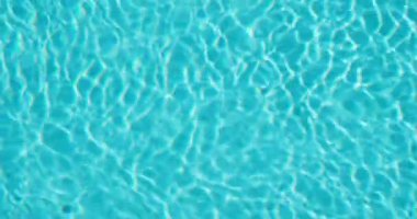 Karmaşık ışık desenleri ve dalgalanmaları olan parlak mavi havuz suyu rahatlatıcı ve dinamik bir su dokusu sunuyor. Yüksek kalite 4k görüntü