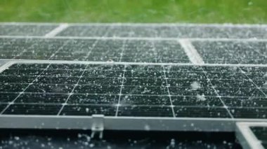 Dolu fırtınası şiddetli bir yağmur sırasında güneş panellerini etkiler, bu da panellerin güçlü dayanıklılık ve aşırı hava koşullarında güvenilir performans gösterdiğini gösterir. Yüksek kalite 4k görüntü