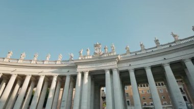 Aziz Peters Meydanı Colonnade Aziz heykelleri ile Vatikan, Roma, İtalya 'da açık mavi gökyüzü.