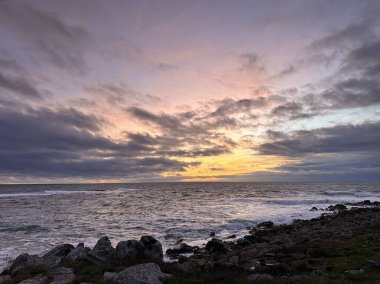 Colorful sunset over the rocks on the coast of the Atlantic Ocean near A Guarda, Galicia, Spain, December 2023