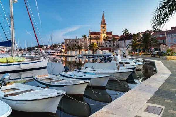 Şafak vakti Hırvatistan 'ın Brac adasında demirli tekneleri olan eski Milna kasabası..