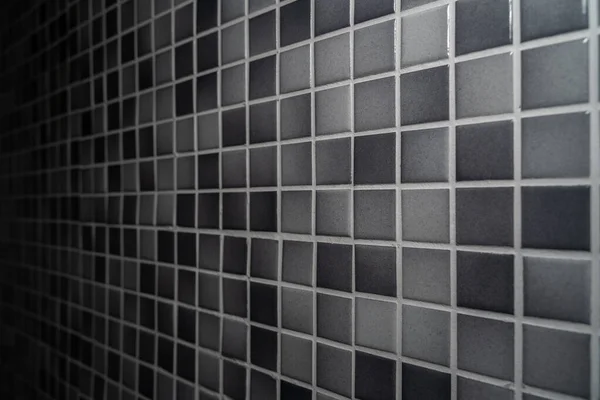 stock image Bathroom wall made of small light gray and dark gray mosaic tiles and silver gray grout